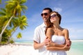 Happy couple in sunglasses over tropical beach Royalty Free Stock Photo