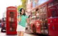 Teenage girl in phones with smartphone over london Royalty Free Stock Photo
