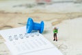 Travel, tourism, vacation or wanderlust life concept, miniature young man backpacker standing on vintage world map with compass,