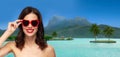 Woman with sunglasses over bora bora beach