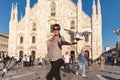 Travel tourist woman near Duomo di Milano - the cathedral church of Milan in Italy. Blogger girl enjoying on the square in the Royalty Free Stock Photo