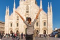 Travel tourist woman near Duomo di Milano - the cathedral church of Milan in Italy. Blogger girl enjoying on the square in the