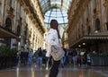 Travel tourist woman near Vittorio Emanuele gallery and Duomo di Milano - cathedral church of Milan in Italy. Blogger girl