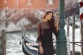 Travel tourist woman on pier against beautiful view on venetian chanal in Venice, Italy. Royalty Free Stock Photo