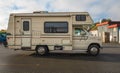 Travel trailer camper van parked. Modern campervan recreational motor home vehicles parked at camper park site Royalty Free Stock Photo