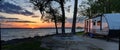 Travel trailer camping at sunset by the Mississippi river in Illinois at sunset panorama Royalty Free Stock Photo