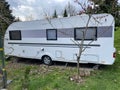 A travel trailer at a caravan camping site concept. Royalty Free Stock Photo