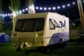 Travel Trailer Caravaning. RV Park Camping at Night. European mobile home on a camping site at night Royalty Free Stock Photo