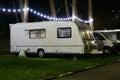 Travel Trailer Caravaning. RV Park Camping at Night. European mobile home on a camping site at night