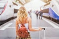 Travel by train, woman passenger with suitcase