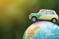 Travel and transport concept, car on world map balloon with green nature background. Royalty Free Stock Photo