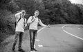 Travel and transport concept. Twins men at edge of road nature background. Reason people pick up hitchhikers. Missed Royalty Free Stock Photo