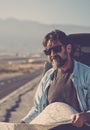 Travel transport people lifestyle. man looking the roads and using paper guide map to find destination and arrival time. Royalty Free Stock Photo