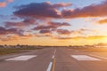 Travel and transportation concept. Empty airplane runway with dramatic sunset light