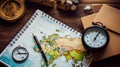 Travel, trip vacation, tourism mockup - close up of compass, glass of water note pad, pen and toy airplane, and touristic map on Royalty Free Stock Photo