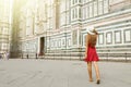 Travel in Tuscany. Back view of beautiful girl visiting Florence Cathedral on sunny day. Summer holidays in Italy