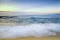 Beautiful tropical beach sunrise sea view. soft wave hitting sandy beach Royalty Free Stock Photo