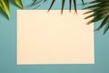 Blank paper in a frame of  leaves of tropical plants on a green background. Royalty Free Stock Photo