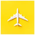 Travel, vacation concept. White model airplane on yellow color background with copy space. Top view. Flat lay. Minimal style Royalty Free Stock Photo