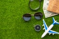 Travel and vacation. Green grass, summer mood. Airplane, compass and passport. With space for design. Agency tour