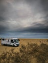 Travel vacation lifestyle with camper parked at the beach with sea view- Recreational vehicle camping car camp in the nature.