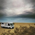 Travel vacation lifestyle with camper parked at the beach with sea view- Recreational vehicle camping car camp in the nature.