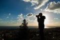 Travel, vacation, photographer and hitchhiker concept - Silhouette of traveler man photographed nature Royalty Free Stock Photo