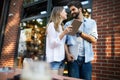 Travel, vacation, technology and friendship concept. Smiling couple with tablet in city Royalty Free Stock Photo