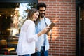 Travel, vacation, technology and friendship concept. Smiling couple with tablet in city Royalty Free Stock Photo