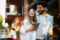 Travel, vacation, technology and friendship concept. Smiling couple with tablet in city Royalty Free Stock Photo