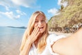 Travel vacation tourist blonde teen girl selfie photo with phone on tropical holiday Royalty Free Stock Photo