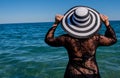 Travel vacation woman on holiday in sunhat enjoying looking view of ocean on hot summer day Royalty Free Stock Photo