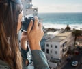 Travel, view and woman with camera at hotel taking pictures of the city, buildings or ocean on vacation. Photographer Royalty Free Stock Photo