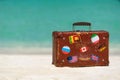 Travel vintage suitcase is alone on a beach