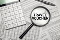 TRAVEL VOUCHER word on magnifying glass with calculator and documents