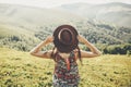 Travel and wanderlust concept. traveler hipster girl holding hat