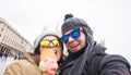 Travel in winter and Italy concept - Happy young couple take selfie photo with ice-cream in front of Milan Duomo Royalty Free Stock Photo