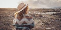 Travel woman concept lifestyle with back view of female people with trendy hat and jacket admiring sunset in the desert landscape Royalty Free Stock Photo