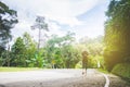 Travel woman with hat and backpack walking on a road Royalty Free Stock Photo