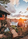 Travel woman looking sunrise view Tree House with Daimond  beach, Nusa Penida island Bali ,Indonesia Royalty Free Stock Photo