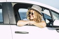 Travel woman smiling and adminring outside the car window in summer holiday vacation parking. Journey and road trip concept people Royalty Free Stock Photo