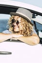 Travel woman smiling and adminring outside the car window in summer holiday vacation parking. Journey and road trip concept people Royalty Free Stock Photo