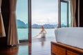 Travel Woman in White Dress Sitting Outdoor near Wooden House on Water Royalty Free Stock Photo