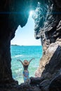 Travel women with maxi dress so happy and relax in a cave near the sea