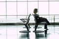 Travel and work online job people at the airport gate - woman sit down and wait for her flight with laptop computer in smart Royalty Free Stock Photo