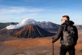 Traveler against fantastic Bromo volcano. Indonesia. Java island