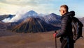 Traveler against fantastic sunrise on the Bromo volcano. Indonesia. Java islan