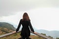 Traveler asia woman look out at viewpoint and feel peace on the woooden fence coner and lay hands down on Kew Mae Pan