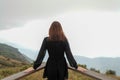 Traveler asia woman look out at viewpoint on the woooden fence coner and make wind blow pass arms on Mountain Kew Mae Pan