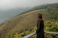 Traveler asia woman look out at viewpoint on the woooden fence on Mountain Kew Mae Pan Doi Inthanon Chiang Mai